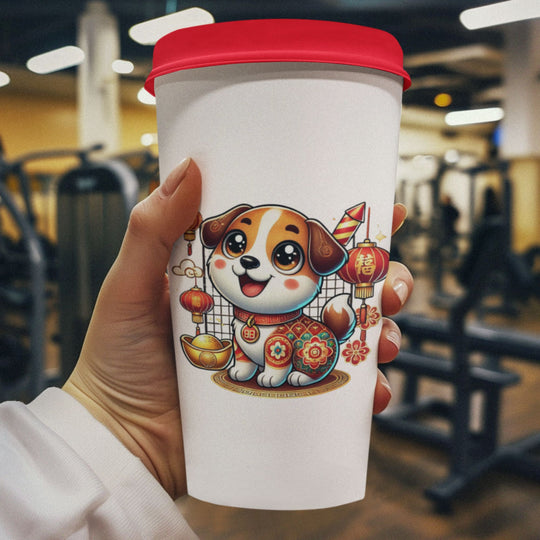 A hand holding a travel cup with a picture of a chinese new year dog